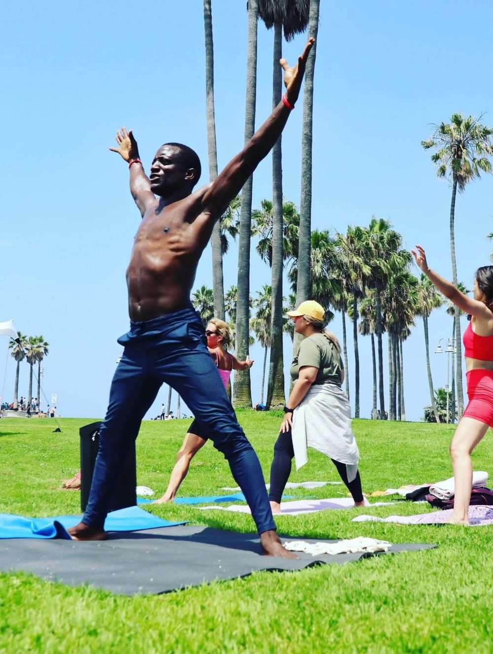 DSA founder Chenfa Dombin leading an outdoor yoga class in Los Angeles