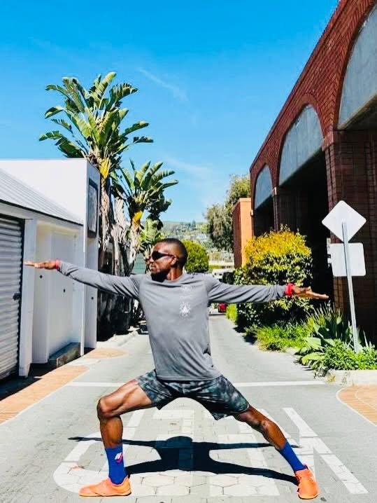 DSA founder Chenfa Dombin in a warrior yoga pose outdoors
