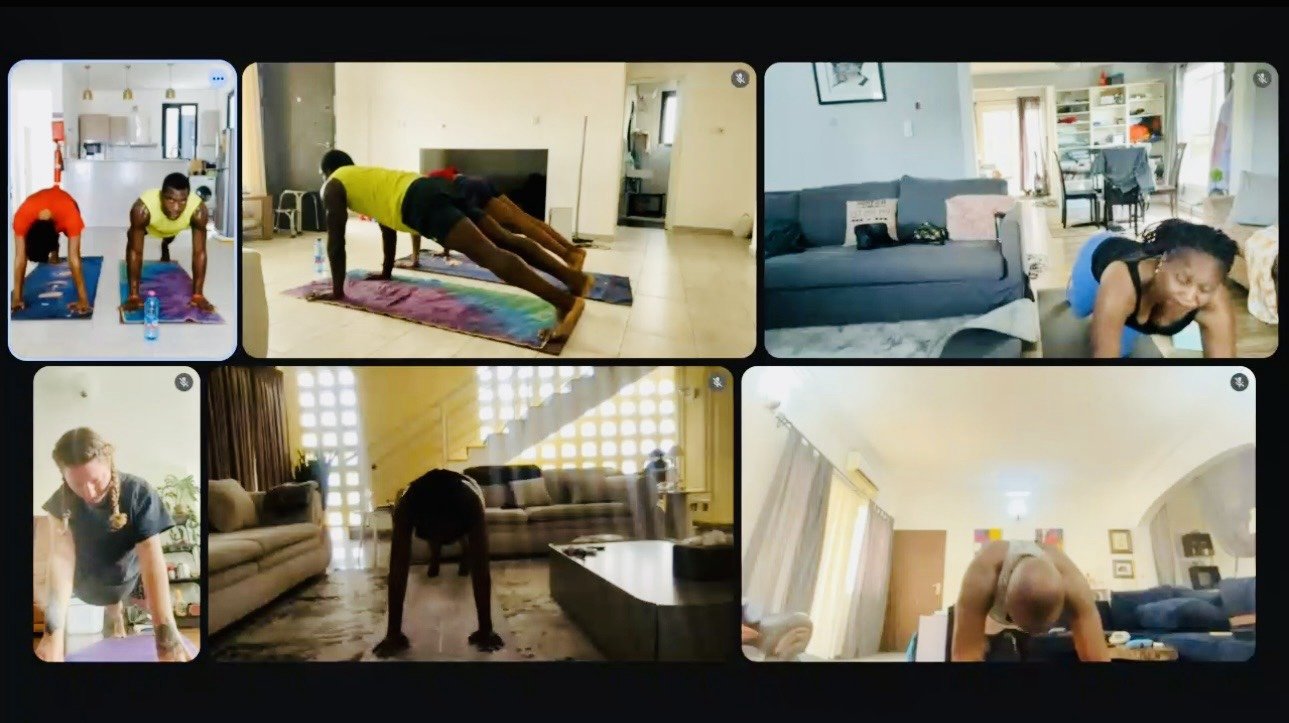 Screen capture of a 2026 Dombinyoga online yoga class: participants on a video call practicing yoga on mats in their homes